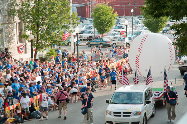 A gigantic baseball rolls past Keystone Little League supporters near City Hall.