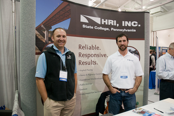Project manager Leif O. Solveson, a 2005 graduate (left) and 2010 alumnus Ryan M. Gordner, a project engineer, staff the HRI Inc. booth. Both earned degrees in civil engineering technology.
