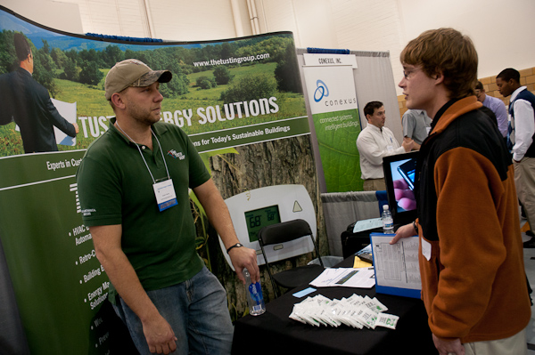 Heating, ventilation and air conditioning design technology student Erich E. Gessitz talks with alumnus Dustin A. Yocom ('05, building automation technology) at the Tustin Energy Solutions booth.