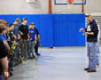 Wildcat archery coach Chad Karstetter talks with youths in the college's Field House