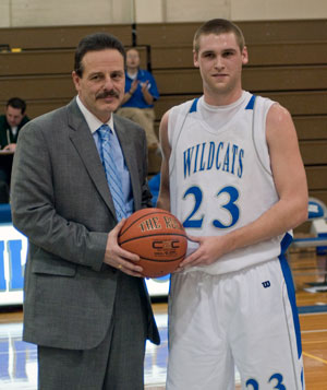 Joe Simon receives congratulations (and a game ball) from Wildcat men's coach Gene Bruno.
