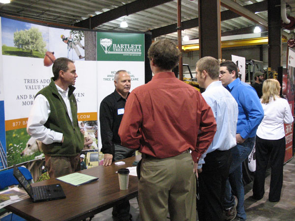 Pennsylvania College of Technology welding and fabrication engineering technology graduates Jacob D. Fisher, center, and Timothy J. Schanken, right, join John Deere co-worker Steven Hart at the college%E2%80%99s career fair. (Photo by Whitnie-Rae Mays, student photographer)