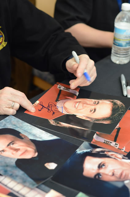 Walter Koenig busily signs photos of his beloved "Star Trek" character.