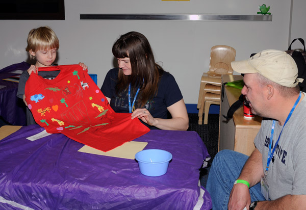 Using supplies from the college's Early Educators Club (and a fair amount of innate artistic talent), Jack Peters crafted a personalized cape at a workshop attended with his parents.