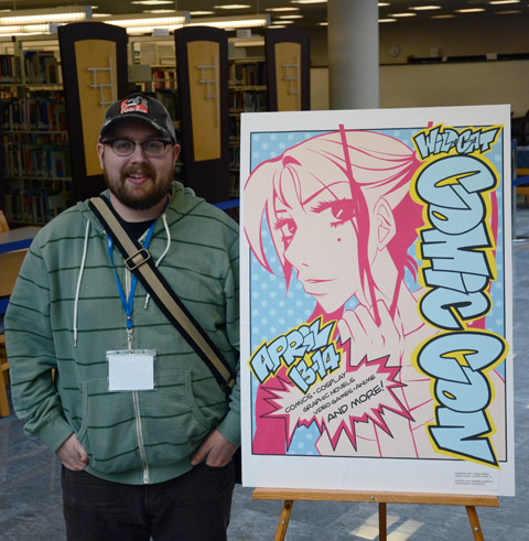 Anthony P. LeVan Jr., among the winners in a poster contest, stands by his design  inspired (and now autographed) by event presenter Tania del Rio.