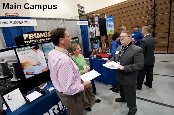 Nathan A. Hyde, a banking and finance major, talks with Sam Shea and Kim Kramm from Primus Technologies Corp.