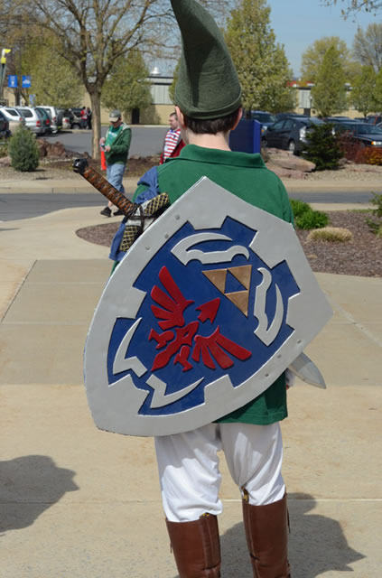 A cosplay contestant, dressed as Link, the courageous protagonist of Nintendo's "Legend of Zelda" games, displays his intricate shield.