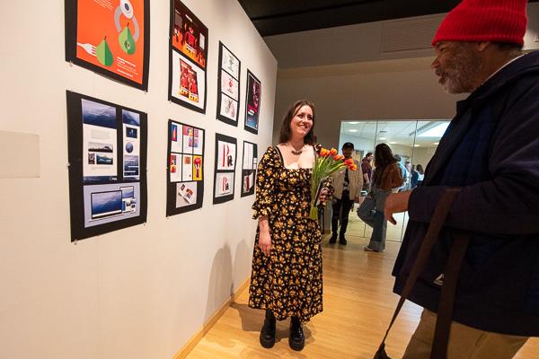 With tulips in hand, Chloe N. Taylor, of Montoursville, converses with an art supporter.