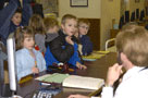 Second-graders ask cataloging librarian Alan W. Buck about the reference desk