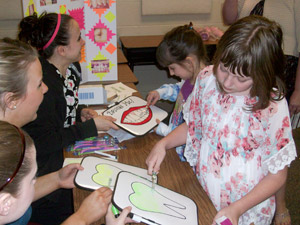 Children participate in learning activities developed by dental hygiene students.