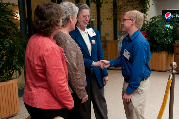 Showing his appreciation, Murray shakes the hands of each of Carl's daughters.