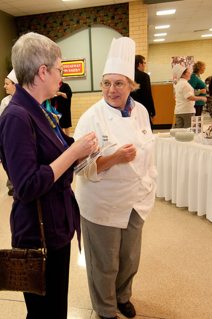 Mindy Cronk, left, branch manager of W.W. Grainger Inc.'s Scranton location, chats with Patricia A. Bennett, a graduating sophomore in baking and pastry arts from West Milton ... 