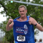 Registrar Denny Dunkleberger shows off his team shirt during the Danville half-marathon.