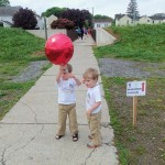 Chet's grandsons, Liam and Colin Moore, share a balloon in the spirit of the day.