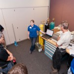 Olivia R. Beaver, student and research assistant, and PIRC Project Manager Gary E. McQuay (left background) explain how a Gardner Impact Test gauges a material's strength.
