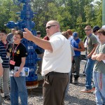 Gathering around a wellhead used in simulated emergencies, students hear Craig Konkle, of the Lycoming County Department of Public Safety, explain the ETEC's value in training responders.