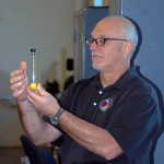 A conference attendee tests a sample during a lab comparison of traditional vs. ethanol-based fuels.