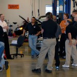 Randy Bridgewater, a training center coordinator for American Honda (in white shirt), leads a session in the Parkes Automotive Technology Center.