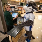 The college's Wildcat mascot goes "green," opting for a reusable takeout container from the Keystone Dining Room.