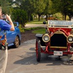 Christopher H. Van Stavoren, associate professor of automotive technology, photographs a 1909 Chalmers on loan to the new auto-restoration major.