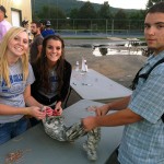 Nathaniel J. Fritter, of Auburn, a building construction technology major who plans to enlist in the Army, brought fatigues to tie-dye in honor of family members already in military service. Lending a hand are Lady Wildcats Caitlyn A. Curley, a pre-nursing student from Middletown (left), and Courtney L. Gernert, a graphic design major from Palmyra. (Photo by volleyball coach Bambi A. Hawkins)