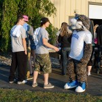 Their soon-to-be-dyed T-shirts slung over their shoulders, students enjoy some "face time" with the college mascot.