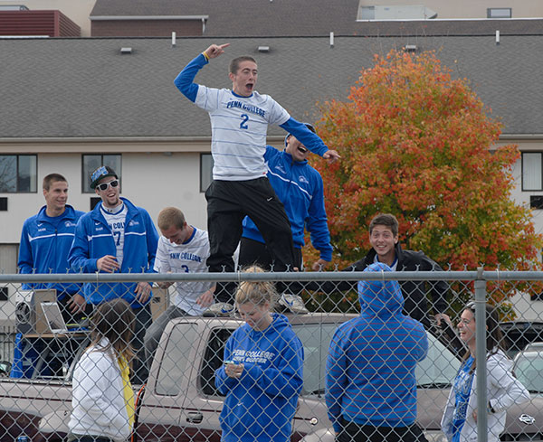 As he and his soccer teammates are declared winners of the Homecoming Tailgate Competition, Christopher P. Brennan exults in an off-field victory.