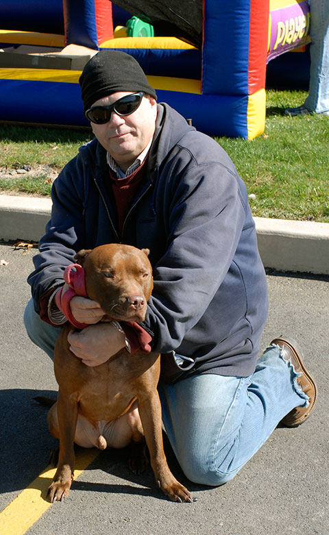 Web and applications development student  Walter R. Toomes, a member of Students Making a Contribution, and Maximus, his red-nosed pit bull from the SPCA, were among those enjoying the 