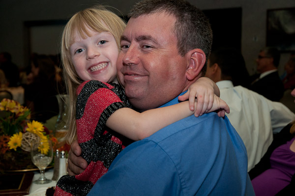 Brian J. Parker, Hall of Famer and Wildcat archery coach, gets a congratulatory hug from his youngest fan: his daughter.