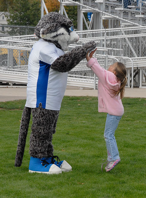 The Wildcat makes a soccer-field friend with a very high five (or two).