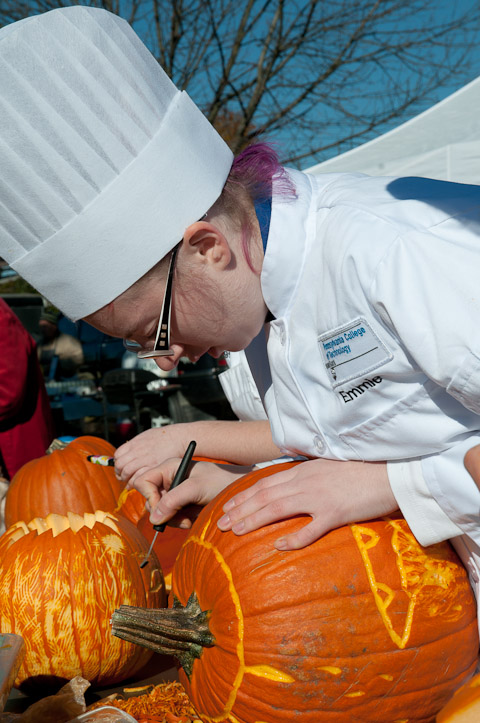 Emmie P.  Leed considers her next move during the pumpkin-carving competition, held downtown by School of Hospitality students.