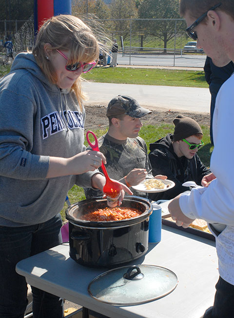 Samantha E. Purcell, an applied human services student, tempts a contest judge with her Buffalo Turkey Chili.