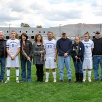 Benjamin W. Shade (9), Ethan J. Dunkle (20) and Daniel M. DeMille (5) gather on the Athletic Field with their families and coaches during Saturday's soccer Senior Day ceremony.