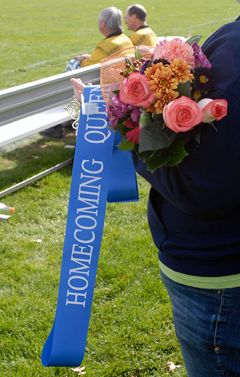Sara R. Hillis, associate director of student activities, holds the Homecoming Queen's sash, crown and flowers moments before the anticipated announcement.