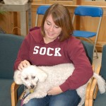 Meghan C. Cunningham, a general studies student from Williamsport, relaxes with Jonas, a Bichon Frise/poodle hybrid owned by Jan Hofer.