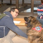 Joseph C. Sarmento, of Williamsport, majoring in applied health studies: radiography concentration, gets acquainted with Koda, a Leonberger owned by Paul Albert.