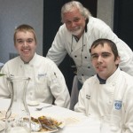 Dennis P. Skinner, assistant professor of horticulture-turned chef for the evening, communes with his grilling assistants, culinary arts and system student Benjamin A. King and culinary arts technology student Bryan A. Sharp.