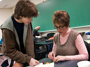 Denise S. Leete, associate professor of computer science at Pennsylvania College of Technology, attempts to follow the Lego “programming” instructions of Curtin Middle School student Adam Chatterton during an after-school visit to the college.