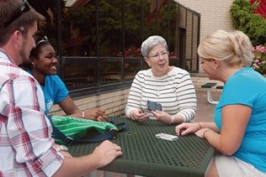 President Davie Jane Gilmour chats with students, from left, Brandon S. Haney, Kacie L. Weaver and Kathrine E. Dixon, in the courtyard outside the Keystone Dining Room.