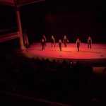 The Wildcat Dance Team "takes the stage" under moody lights ...