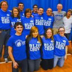 Cross-country coach Mike Paulhamus (far left), along with current and former members of the cross-country team, join the Fischer family for the night's dedication.