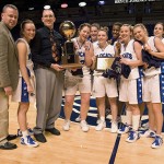 The 2006 women's state basketball champs, with coach Ron Kodish, proudly display their trophy at the Bryce Jordan Center