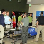 Construction management instructor Jason E. Krick joins classmates Preston K. Nelson and Benjamin J. Stover in talking with students and industry professionals at ACE-Frederick.  