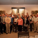 Students and their mentors gather at the rear of the restaurant.