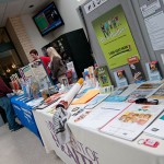 Kristi L. Hammaker (left background) and LaDonna J. Caldwell staff a "Kick Butts Day" table outside the Keystone Dining Room.