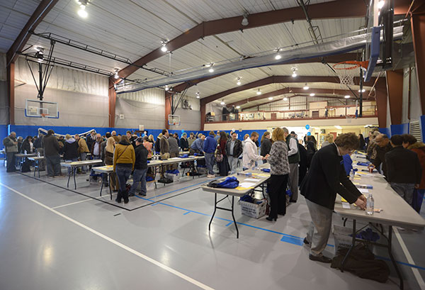Check-in volunteers handle the steady flow through the Field House.