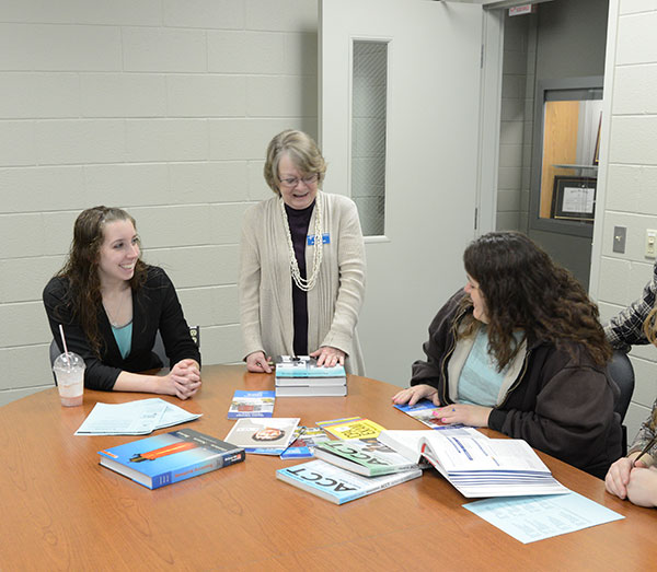 Justine E. Cubberley, an accounting student from Hughesville (left), and JoAnn H. Pacenta, instructor of business administration/accounting (standing), are pleasant and knowledgeable advocates for the School of Business and Computer Technologies.