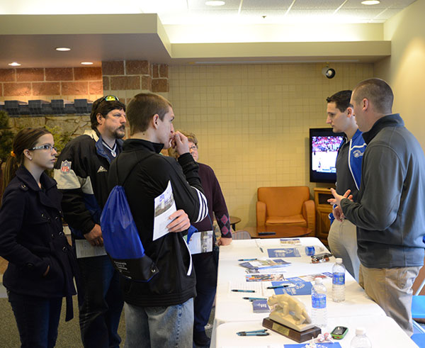 Alumni of the Wildcat basketball team, Tom Little (right background) and Joe Simon – now assistant coaches – talk with interested athletes in the Bush Campus Center TV lounge.