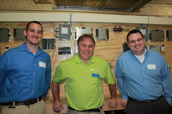 An alumni reunion in the Carl Building Technologies Center: Volunteers Carl F. Gravely, '08 (left), and Adam J. Yoder, '11, return to assist Todd S. Wooding, assistant professor of building automation technology/HVAC electrical, and a 1982 graduate.