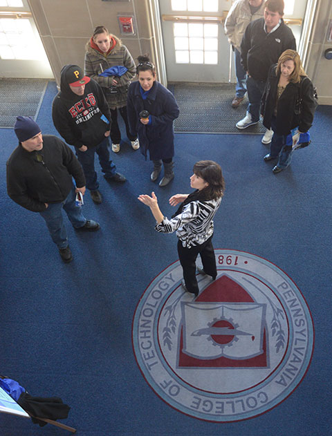 Bambi A. Hawkins, learning laboratory coordinator for the paramedic program, directs Open House visitors to an ACC information session.